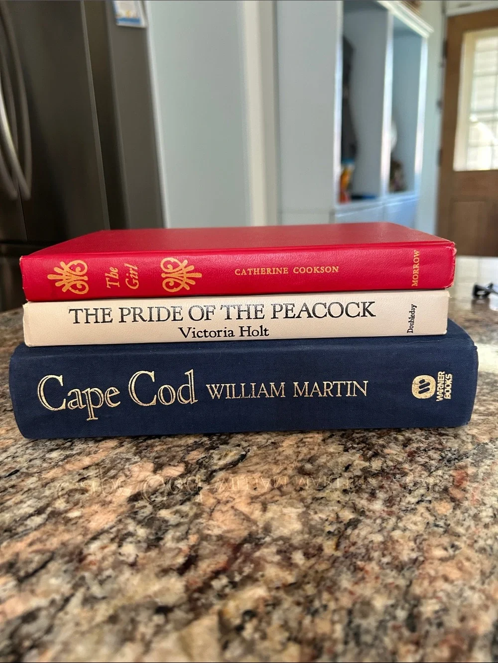 Stack of Decorative Hardcover Books in Red, Cream, and Navy